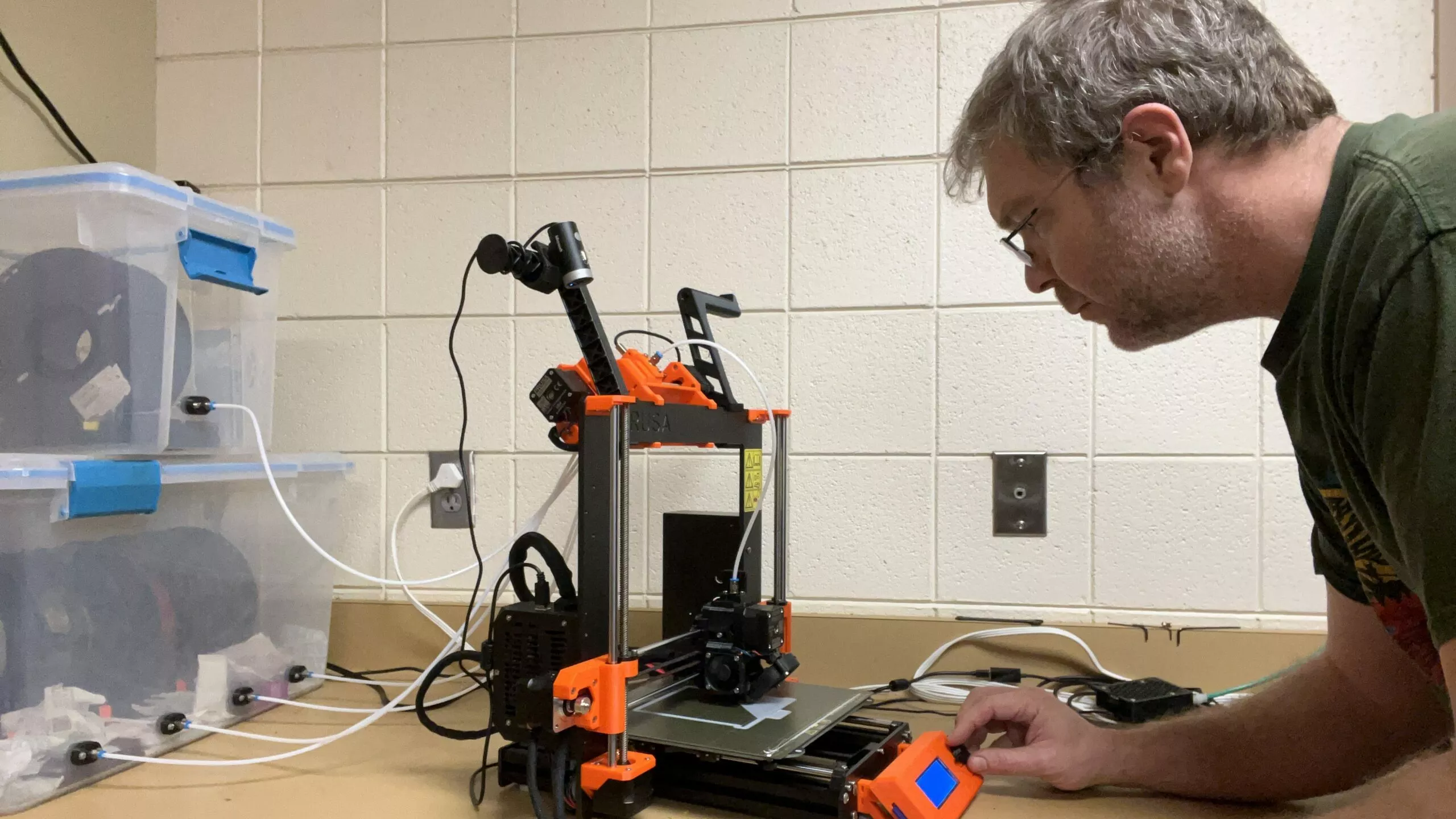 Wayne programs the 3-D printer to build the snail traps.