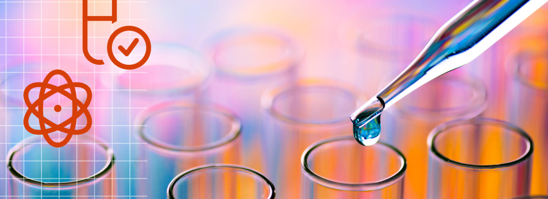 Close up of an eye dropper releasing liquid into a set of test tubes.