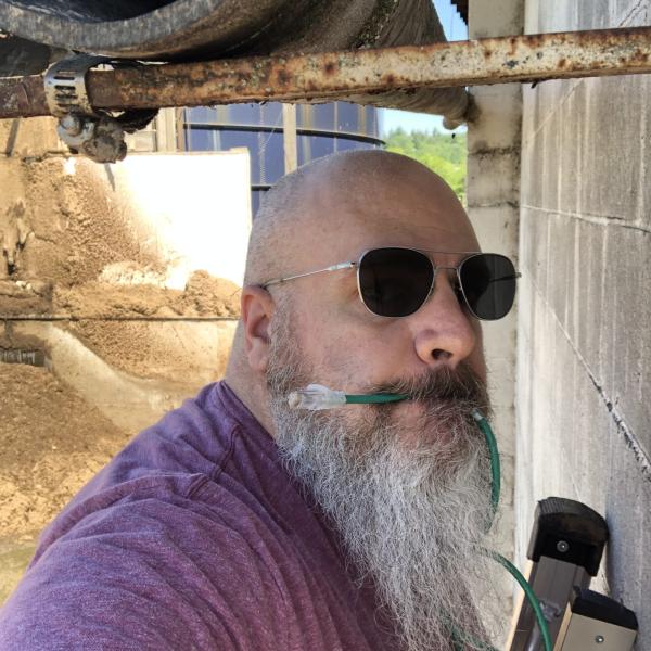 Curt navigates horse manure in order to install research cameras.