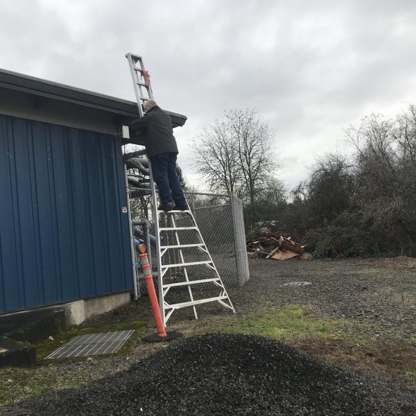 Curt navigates horse manure in order to install research cameras.